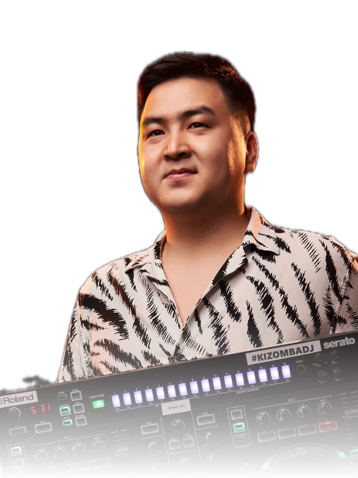 DJ Nurliving in a patterned shirt standing behind a DJ controller