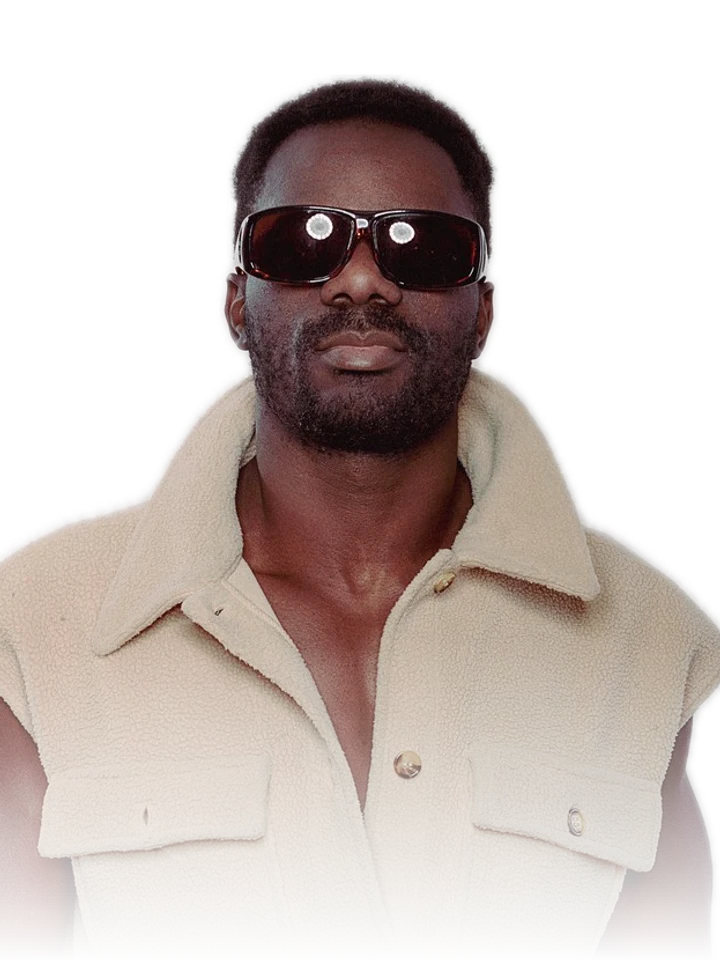 Poema Beatz wearing dark sunglasses and a cream sleeveless jacket